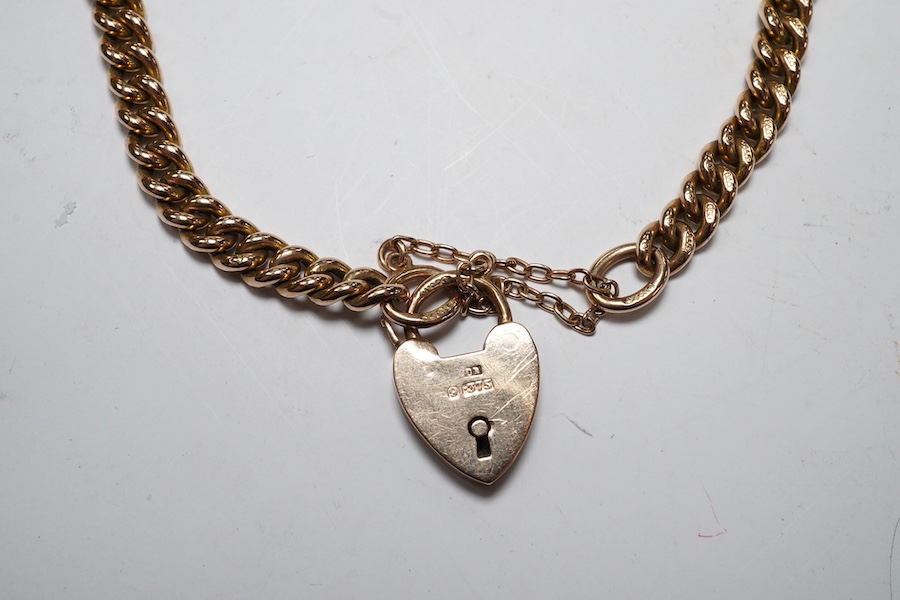 A 9ct god curb link bracelet, with heart shaped padlock clasp, 18cm, 13.8 grams. Condition - fair to good